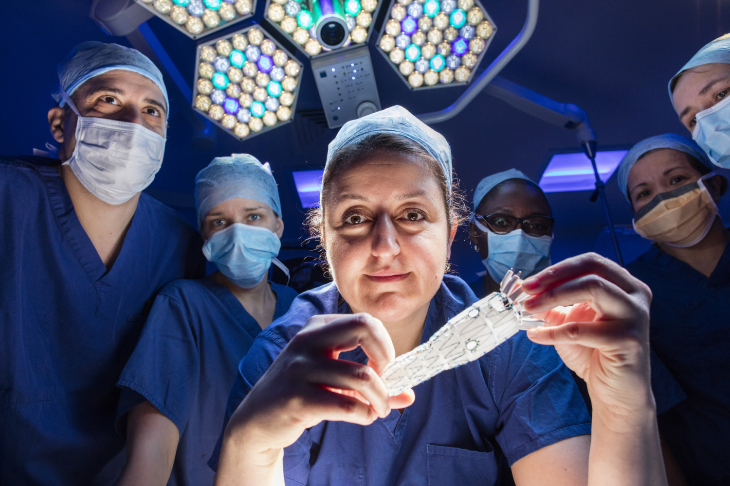 Dr Tara Mastracci, photographed with her team inside a surgical theatre at the Royal Free Hospital in North London, 2015. Photograph by David Levene.