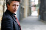 Aidan Gillen is an Irish actor known for his roles in acclaimed television series and films. He gained international recognition for his performances in Game of Thrones and The Wire, establishing himself as a distinctive presence in contemporary television and cinema. London. Photograph by David Levene 21 September 2007
