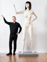 David Shrigley. British visual artist and illustrator known for his distinctive, humorous, and often absurd style. Working across drawing, sculpture, animation, and installations, he combines dark humour with simple, childlike aesthetics to comment on everyday life, society, and human behaviour. Shrigley’s work has been exhibited internationally, earning acclaim for its wit, originality, and ability to provoke thought while entertaining audiences. Photographed with 'Life Model II'. Fabrica, Brighton. Photograph by David Levene 13 April 20218