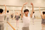 Students from the New National Theatre Ballet School (NNT Ballet School) take part in a daily ballet class. The NNT Ballet School is the official training school for the National Ballet of Japan (NBJ). It is Japan's first theatre-affiliated training institute for aspiring professional ballet dancers. Established in April 2001, the school provides a two-year full-time training program aimed at developing students into professional dancers. Students also participate in NBJ productions, gaining practical stage experience. Tokyo, Japan. Photograph by David Levene 13 March 2025