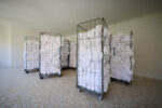 61st International Art Exhibition, Biennale di Venezia, titled In Minor Keys. Lydia Ourahmane. tons of decommissioned bed linen from 200 Venetian hotels, 2026 13 metal cages, bed linen. Venice, Italy. Photograph by David Levene 3/5/26