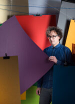 Matt Appleton, British artist known for his work with colour and geometric form, photographed among large suspended sheets of coloured card in his studio, London. Photograph by David Levene, 15 January 2015.