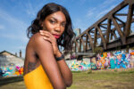 Michaela Coel, British writer, actress and director known for Chewing Gum and I May Destroy You, photographed against a graffiti-covered railway bridge in east London. Photograph by David Levene, 11 September 2015