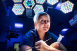 Dr Tara Mastracci, consultant cardiothoracic surgeon, photographed in a hospital operating theatre beneath surgical lights, London. Photograph by David Levene, 1 December 2015