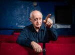 Edward Bond, British playwright whose works include Saved and Lear, seated among the red velvet seats of a theatre auditorium, London. Photograph by David Levene, 9 May 2016