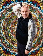 Damien Hirst, British artist known for his work exploring themes of death and mortality, photographed in front of one of his large-scale butterfly wing paintings, London. Photograph by David Levene, 24 September 2019