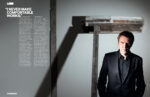 Mirosław Bałka, Polish sculptor known for large-scale installations exploring themes of memory, absence and the human condition, photographed alongside a monumental wooden structure ahead of his Unilever Series commission at Tate Modern, London. Photograph by David Levene, October 2009.